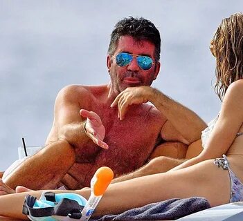 Simon Cowell shows off huge back scar on a yacht in Barbados