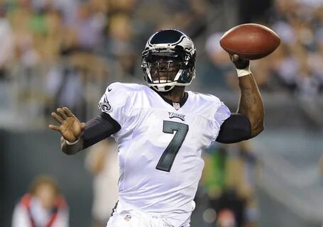 Philadelphia Eagles quarterback Michael Vick celebrates thre