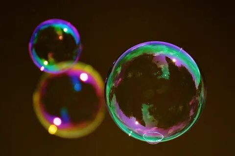 Three soap bubbles on a brown background free image download