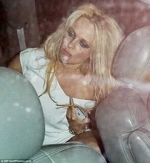 Pamela Anderson emerges wearing exactly the same dress she w