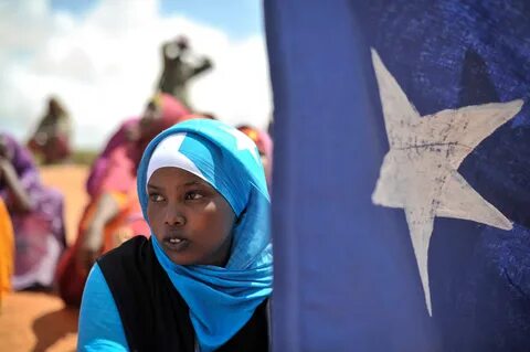 File:A young woman holds the Somali flag during a demonstrat