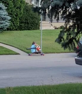 This kid on a longboard using a leaf blower for power is now