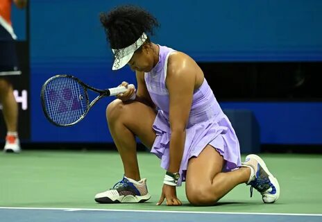 Naomi Osaka falls looks down to the ground during her 7-6, 6-3 loss to Amer...