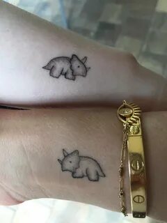 Pair up with your lover with matching dinosaur tattoos