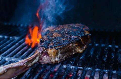 Grilled Tomahawk Steak on an charcoal grill. Samantha Ferrar