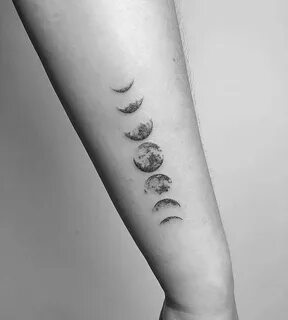 Moon phase tattoo on the right forearm.