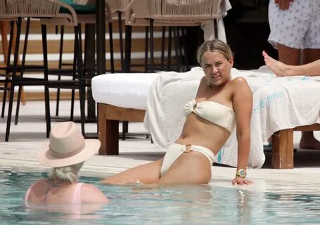 Molly-Mae Hague relaxes by the pool in a thong bikini with n