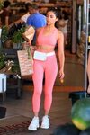 olivia culpo shows off her toned abs in her pink workout gea