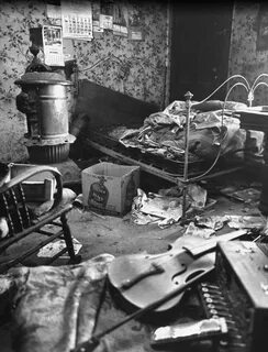 The filthy, cluttered bedroom of Ed Gein is pictured in this