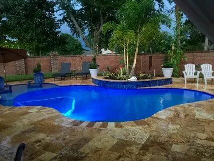 The lagoon pool I designed and love. Travertine tile, dark b