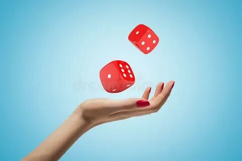 Female Hand Throwing Two Red Casino Dice Up in the Air on Bl