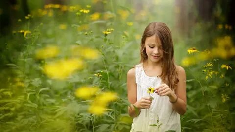 Cute Little Girl With Yellow Flower In Hands Wearign White D