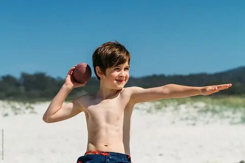 Boy At The Beach Posing With Football by Jess Lewis