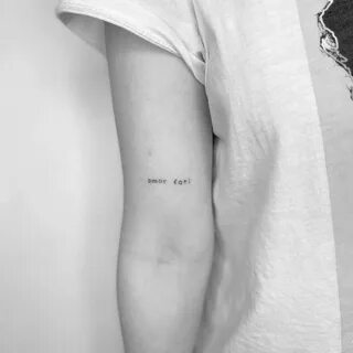 "Amor fati" lettering tattoo on the bicep