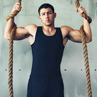 Nick Jonas works out in a Polo tank in the December '16 Men'