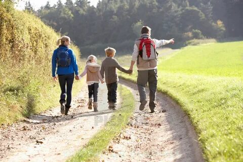 Young family walking in park - License, download or print fo