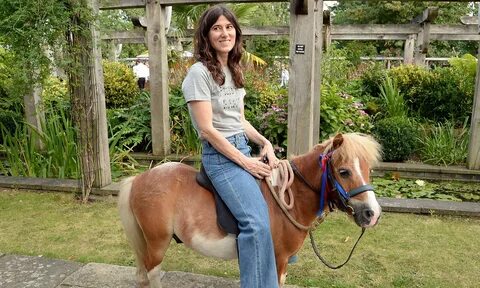 Asian girls riding small pony