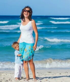 Mother with son on beach stock image. Image of child - 54051