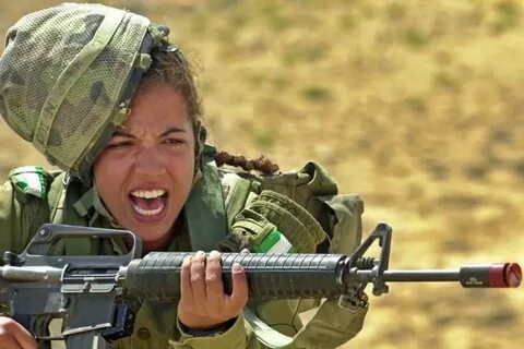 An Israeli army female soldier shouts while holding a M16 ri
