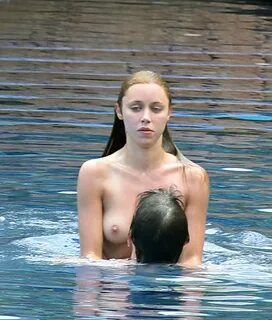 Una Healy topless in the pool in Ibiza dominated by her horn