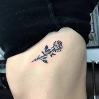 Rose tattoo on the left side ribcage. Tattoo Artist: Romeo L