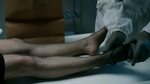 Christina Ricci in black pantyhose lying on a table in After