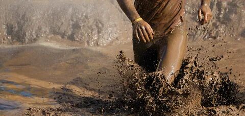 Man running in mud - Dynamic Health Fitness