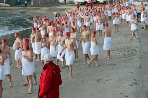 Swimmers arrive for the Dark Mofo nude winter swim in Hobart