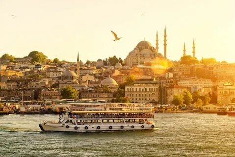 Tourist boat floats on the Golden Horn in Istanbul at sunset