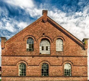 Old red brick building, Facade with arched windows free imag