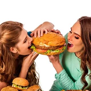 Women eating fast food. Gils eat hamburger with ham . - Lice