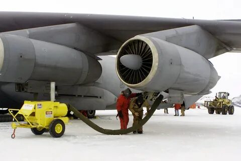 Ground crews install engine heaters on a Lockheed C-141C Sta