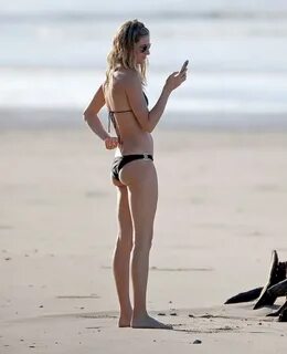 Gisele Bundchen wearing tiny black bikini at the beach in Co