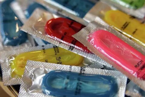 Multi coloured condoms Photograph by Icon Photos Pixels