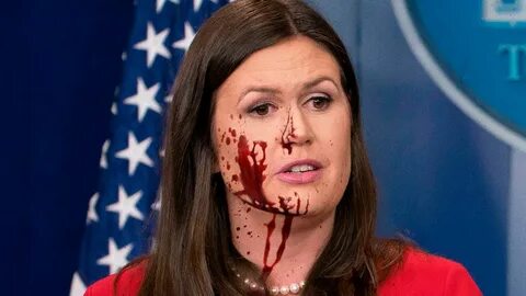 Blood-Spattered Sarah Huckabee Sanders Holds Up Huge Dismemb