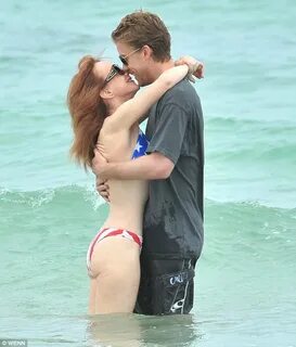 Kathy Griffin and her toyboy beau get frisky in the ocean Da