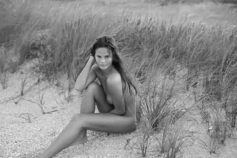 Christine Teigen fully naked at the beach photoshoot by Dori