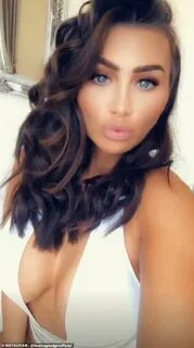 Lauren Goodger flashes major cleavage as writhes around in s