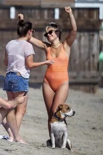 florence pugh seen wearing an orange swimsuit while enjoying