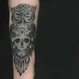 Owl tattoo on the forearm with sugar skull in it. Black and 