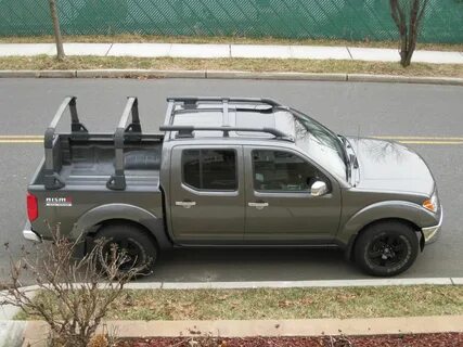 Very good looking Nissan Frontier with bed rack and roof rac