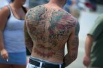 Black, red and blue men's back tattoo