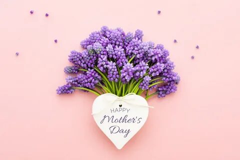 Spring lilac flowers and a heart shape card Happy Mother's Day on pink...