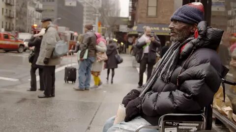 homeless man with oxygen tank in wheelchair begging for chan