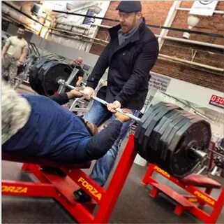 Mark Henry posing with 765 lbs on bench press - Bodybuilding