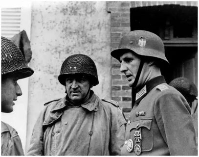 Maj Gen Eddy talking with a German officer Cherbourg, France