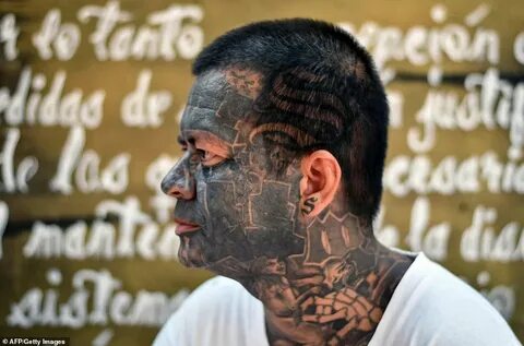 Former gang members in an El Salvadorian prison cross throug