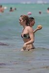 Emily Bett Rickards in a tiny bikini at the beach in Maimi. 