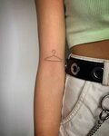 Hand-poked little coat hanger tattoo by Kirk Budden - Tattoo