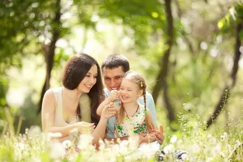 Happy mother, father and daughter playing in the park Stock 